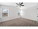 Inviting bedroom with neutral walls, carpeted floors, and natural light coming through multiple windows at 1009 Rhino Bnd, Oxford, NC 27565