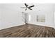 Bright living room featuring wood-look flooring, a ceiling fan, and a staircase leading to the upper level at 1009 Rhino Bnd, Oxford, NC 27565