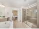 Elegant bathroom with a separate shower and bathtub, next to a bedroom at 1009 Travern Dr, Raleigh, NC 27603