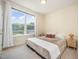 Bedroom with a large window, natural light, a comfortable bed, and side tables at 1009 Travern Dr, Raleigh, NC 27603