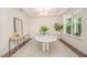 Bright dining room features tray ceiling, modern chandelier, and a unique table creating an elegant space at 1009 Travern Dr, Raleigh, NC 27603
