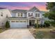 Charming two-story home featuring a well-manicured lawn, inviting front porch, and a convenient attached two-car garage at 1009 Travern Dr, Raleigh, NC 27603