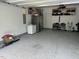 Large garage with epoxy flooring, refrigerator, and built in shelving at 1009 Travern Dr, Raleigh, NC 27603