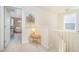 Hallway with a decorative table, painting, and stairway, leading to a carpeted landing at 1009 Travern Dr, Raleigh, NC 27603