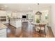 Open kitchen and living area with stainless steel appliances, granite countertops, and hardwood flooring at 1009 Travern Dr, Raleigh, NC 27603