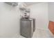 Modern laundry room with gray washer and dryer and overhead storage at 1009 Travern Dr, Raleigh, NC 27603