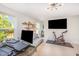 Bright living room features a modern light fixture, TV and exercise bike at 1009 Travern Dr, Raleigh, NC 27603