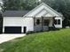 New construction with white siding, black trim, and a charming front porch at 101 Cochise Cv, Louisburg, NC 27549