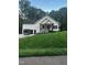 New construction with white siding, black trim, and a charming front porch with a green lawn at 101 Cochise Cv, Louisburg, NC 27549