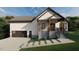 Charming two-story home featuring a covered porch, black trim, and a convenient attached garage at 101 Cochise Cv, Louisburg, NC 27549