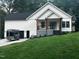 New construction with white siding, black trim, and a charming front porch at 101 Cochise Cv, Louisburg, NC 27549