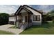 Charming two-story home featuring a covered porch, black trim, and a convenient attached garage at 101 Cochise Cv, Louisburg, NC 27549
