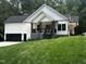 Charming new construction with white siding, black trim, and a well-maintained lawn at 101 Cochise Cv, Louisburg, NC 27549