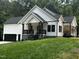 Charming new construction with white siding, black trim, and a well-maintained lawn at 101 Cochise Cv, Louisburg, NC 27549