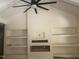 Bright open living room with tall vaulted ceilings and a fireplace with built in shelving at 101 Cochise Cv, Louisburg, NC 27549
