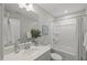 Bright bathroom with quartz countertops, modern fixtures, and a shower/tub combo at 1011 Canary Pepper Dr, Durham, NC 27713