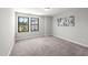 Bright, carpeted bedroom features neutral walls and large windows providing great views of the neighborhood at 1011 Canary Pepper Dr, Durham, NC 27713