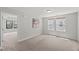 A well-lit bedroom shows neutral walls, carpet, and an open doorway, offering a blank canvas for personalization at 1011 Canary Pepper Dr, Durham, NC 27713