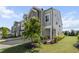 Well-maintained gray townhouse with landscaped front yard and manicured lawn at 1011 Canary Pepper Dr, Durham, NC 27713