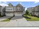 Attractive gray townhouse with two-car garage, a driveway, and well-maintained front lawn at 1011 Canary Pepper Dr, Durham, NC 27713