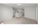 The carpeted hallway features neutral paint, multiple rooms, and is a common area in the home at 1011 Canary Pepper Dr, Durham, NC 27713