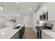Modern kitchen with a central island, stainless steel appliances, and an open view into the living area at 1011 Canary Pepper Dr, Durham, NC 27713