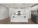 Modern kitchen features a large island, stainless steel appliances, and stylish pendant lighting at 1011 Canary Pepper Dr, Durham, NC 27713