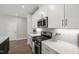 Charming kitchen showcasing white cabinets, stainless steel appliances, white countertops, and a herringbone tile backsplash at 1011 Canary Pepper Dr, Durham, NC 27713