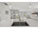 Bright kitchen with open layout, featuring an island with sink and stainless steel appliances at 1011 Canary Pepper Dr, Durham, NC 27713