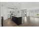 Bright kitchen features stainless steel appliances, white cabinets, pendant lighting, and hardwood floors at 1011 Canary Pepper Dr, Durham, NC 27713