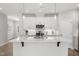 Bright kitchen featuring white cabinetry, stainless steel appliances, and a spacious center island at 1011 Canary Pepper Dr, Durham, NC 27713