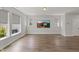 Bright living room with large windows and wood floors, perfect for relaxing and entertaining at 1011 Canary Pepper Dr, Durham, NC 27713
