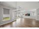 Well-lit living room featuring wood floors and modern lighting at 1011 Canary Pepper Dr, Durham, NC 27713