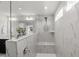 Modern shower featuring white marbled tile and bench seating at 1011 Canary Pepper Dr, Durham, NC 27713
