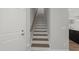 Staircase featuring wood treads and white risers, leading to the second floor at 1011 Canary Pepper Dr, Durham, NC 27713