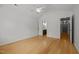Bedroom showcasing wood floors, fan, and an open entrance to a bathroom with a wood vanity at 1040 Mills St, Raleigh, NC 27608