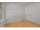 Bedroom featuring hardwood floors, a window, and closet with double doors at 1040 Mills St, Raleigh, NC 27608