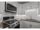 Updated kitchen features stainless steel appliances, modern cabinets, and a stylish backsplash at 1040 Mills St, Raleigh, NC 27608