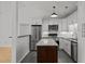 Modern kitchen featuring stainless steel appliances, stylish island, and updated lighting at 1040 Mills St, Raleigh, NC 27608