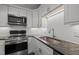 Stylish kitchen featuring stainless steel appliances and subway tile backsplash at 1040 Mills St, Raleigh, NC 27608