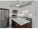 Bright kitchen with stainless steel appliances, white cabinets, island, and modern backsplash at 1040 Mills St, Raleigh, NC 27608