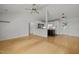 Spacious living room with ceiling fan, hardwood floors, and an open view into the kitchen at 1040 Mills St, Raleigh, NC 27608