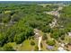 Wide aerial shot featuring a secluded property in a wooded location with a private pool at 105 Kirkland Ct, Archer Lodge, NC 27527