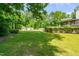 Lush green backyard with a storage shed, and home exterior with covered back porch at 105 Kirkland Ct, Archer Lodge, NC 27527