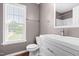 Bathroom featuring a white vanity, toilet, and a bright window at 105 Kirkland Ct, Archer Lodge, NC 27527