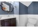 This half bathroom has a modern vanity and stylish wainscoting for added elegance at 105 Kirkland Ct, Archer Lodge, NC 27527