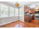 Bright breakfast area with hardwood floors, a Tiffany style pendant light and multiple windows at 105 Kirkland Ct, Archer Lodge, NC 27527