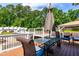 Relaxing deck area with an umbrella-covered table, wicker chairs, and a view of the pool at 105 Kirkland Ct, Archer Lodge, NC 27527