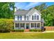 Charming two-story white home with black shutters, a brick walkway, and a beautifully landscaped front yard at 105 Kirkland Ct, Archer Lodge, NC 27527