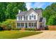 Charming two-story white home with black shutters, a brick walkway, and a gravel driveway at 105 Kirkland Ct, Archer Lodge, NC 27527
